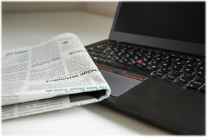 Newspaper on laptop computer